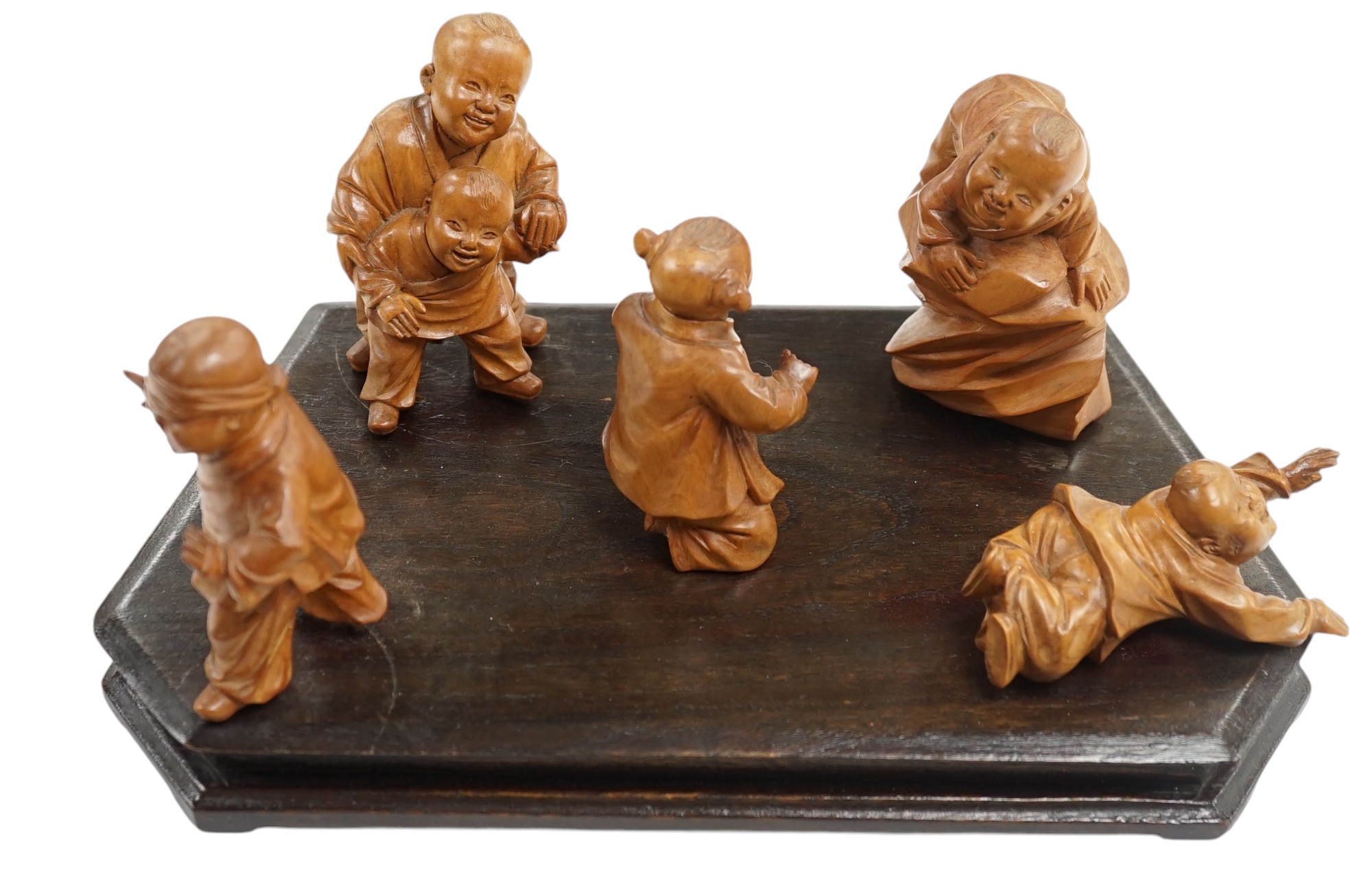 A set five Chinese carved boxwood figures of children playing Blind man’s Buff, Republic period, 23cm wide. Condition - good